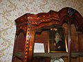 ;Rawlinson display cabinet 1772 The highly decorated cabinet featuring carving marquetry and gilding was commisssioned by the Quaker, Mary Hutton Rawlinson widow of Thomas Hutton Rawlinson, the ironmaster and West Indies merchant who traded from Lancaster. Thomas was a slave trader. It was executed by Thomas and John Dowbiggin, Thomas was the father of Francis Dowbiggin. Its significance is that it documented in the Gillow's Estimate Books in great detail.