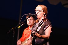 Veirs onstage playing guitar