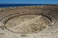 The remains of Leptis Magna amphitheater, with the sea visible in the background Leptis Magna amphitheatre - panoramio.jpg