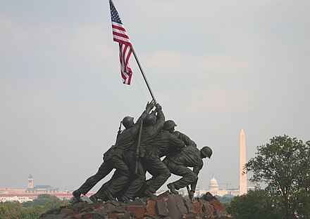 The U.S. Marine Corps War Memorial in Arlington with the Washington Monument and the United States Capitol in the distance.