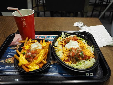 A Naked Burrito Bowl with seasoned French fries and a soft drink at a Taco Bell in Finland