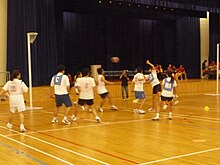 Short and t-shirt wearing players compete against each other.