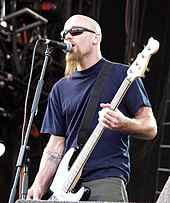 Nick Oliveri, bassist 1998-2004, performing with the band at the 2003 V Festival Nick Oliveri V Festival 2003.jpg