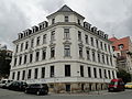 Apartment house in a corner and open development