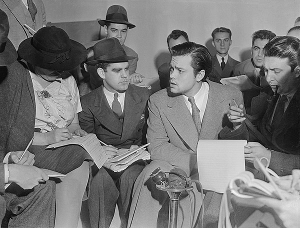 Orson Welles interviewed by reporters after his 1938 radio adaptation of The War of the Worlds caused a panic.