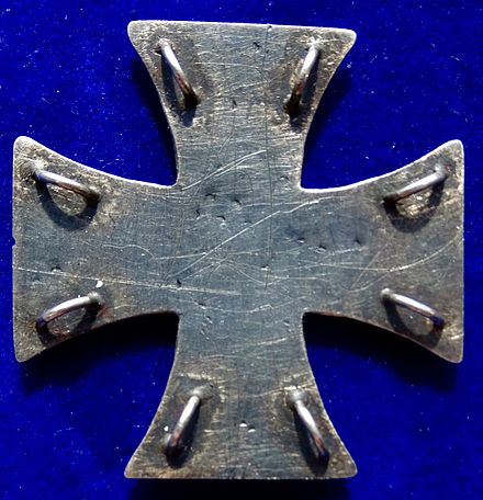 Reverse side of the above cross showing eight metal loops for stitching the award to the left side of the uniform breast.