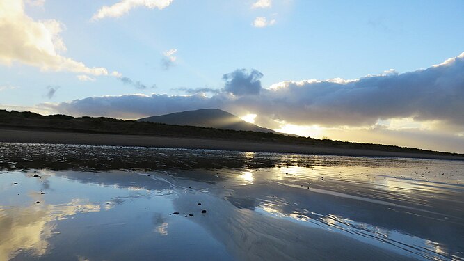Reflections of clouds on wet sand, County Kerry, Ireland.