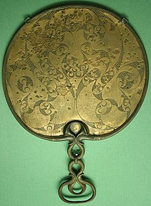 Ana e mbrapme e një pasqyre bronxi Keltike nga Desborough, Northamptonshire, England, qe shfaq zhvillimin e temave dekorative te spirales dhe trumbetes, stili i hershem Kelt La Tène ne Britani. Daton midis 50 para dhe pas K. Modeli simetrik fletë-mbulues i krijuar duke perdorur një kompas ose fije.