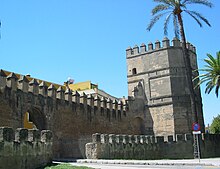 City Walls and the Torre Blanca in the barrio de la Macarena. In this image, seen one of the two postigos opened to promote communication in the intramural area with the new round. Seville Old City Wall.JPG