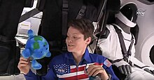 Expedition 58 crew member Anne McClain poses with "Little Earth" inside C204; the capsule was docked to the ISS for five days. SpaceX DM1 - Anne McClain - Litte Earth.jpg