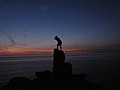 Silhouetted figure on the cliffs