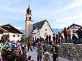 The grand finale of the procession in the streets of Fiss where a bear pulls a big pine log through the streets during carnaval celebration 'Fisser Blochziehen'