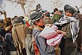 Two brothers help each other carry bags of beans and rice in Pinzo village, Nawbahar district, Zabul province, Afghanistan, Feb 120205-N-UD522-145.jpg