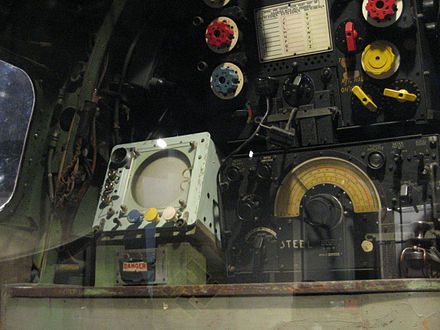 Fishpond display (square grey box with circular screen) mounted in radio operator's position aboard an Avro Lancaster.
