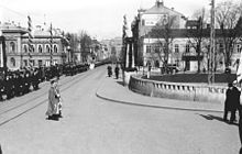 Street view of several university buildings, with several people walking in the streets