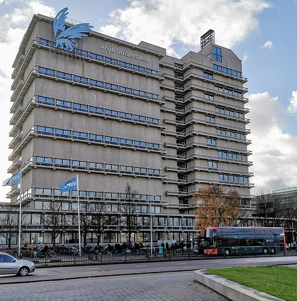 The upper floors of the Main Building's eastern wing, housing library stacks and showing the university emblem.