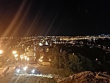 The city viewed from the top of the monument hill at night