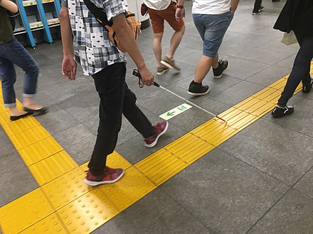 Tactile paving can assist the visually impaired as they walk.