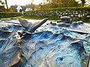 "Table at the Cliff", Bronze reliefs "Whale in a moving sea" and "Hill grave" by Ingo Kühl 2019