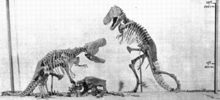 Rysunek przedstawiajcy dwa dinozaury siedzce jeden na drugim.