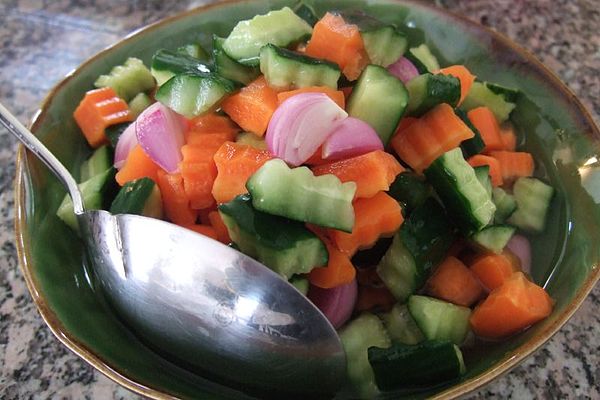 Acar made of cucumber, carrot and shallot bits in vinegar