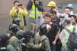 Hong Kong Legislative Council member Lam Cheuk-ting arguing with riot police.