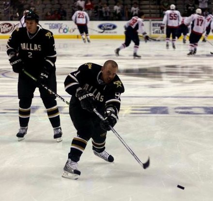 Brad Richards shoots the puck in pregame warm-up during the 2008–09 season. Injuries to Richards and other teammates during the course of the 2008–09 season led the Stars to miss their first playoffs since 2002.