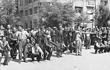 Greek Jews from Saloniki are forced to exercise or dance, July 1942. Bundesarchiv Bild 101I-168-0895-05A, Griechenland, Saloniki, Erfassung von Juden.jpg
