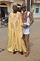 Image 23Cameroonian fashion is varied and often mixes modern and traditional elements. Note the wearing of sun glasses, monk shoes, sandals, and a Smartwatch. (from Cameroon)