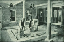 Children performing manual labor at the State School of Industry in 1887. Children Bricklaying At House.png