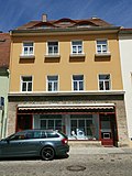 Residential building with shop in closed development