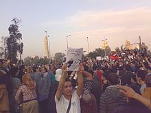 A demonstration in Cairo. The sign has an open source caricature by Carlos Latuff which features shoeing. Demonstration in Imaba, Cario.jpg