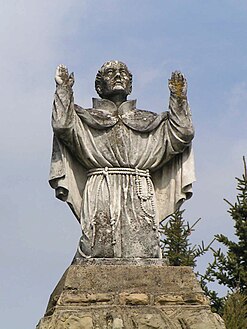 Dukla - statue St. John of Dukla on the courtyard in front of the church of the Bernardine Fathers.jpg