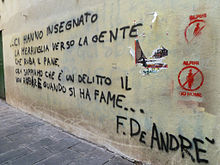 Scritta comparsa nei quartieri vecchi di Genova, che riporta alcuni versi della canzone Nella mia ora di libertà, da Storia di un impiegato (1973)