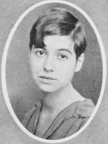 A young white woman with dark hair in a pixie cut, in an oval frame