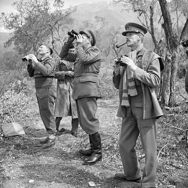 Lieutenant General Leese, GOC Eighth Army, with his corps commanders, including Kirkman, GOC XIII Corps, standing closest to the camera, watching an A