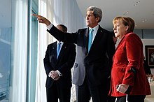 Kerry and Angela Merkel, 2014 German Chancellor Merkel, Secretary Kerry Look Out at Berlin Landmarks (12237060675).jpg