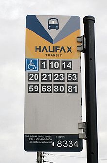 A Halifax Transit bus stop sign with new Departures Line info, high contrast route numbers, and Halifax Transit branding. Sign shows westbound routes from stop in front of Lord Nelson arcade on Spring Garden Road east of South Park Street. Halifaxtransitbusstopsign2016.jpg