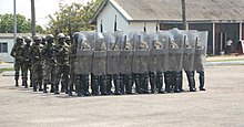 Members of the Ghana Army 2nd Engineer Battalion assemble in a riot control formation during nonlethal training June 26, 2013, in Accra, Ghana, as part of exercise Western Accord 2013 130626-A-ZZ999-003.jpg