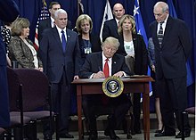 President Trump signs an executive order at a ceremony at DHS headquarters. POTUS visits DHS (32174751680).jpg