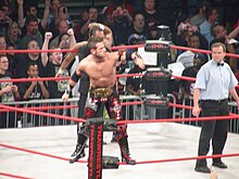 Shelley with an IWGP Junior Heavyweight Tag Team Championship belt at Slammiversary 2009 Revvin' in the Motor City.jpg