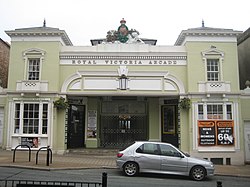 Entrance to Royal Victoria Arcade with metal railings in the centre