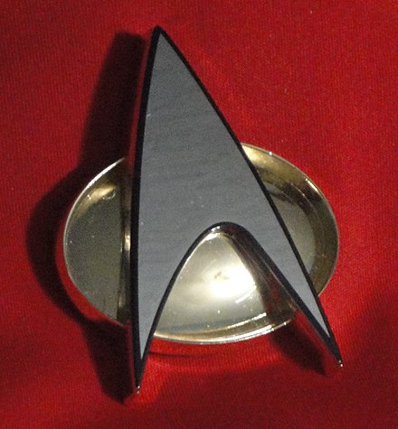 Starfleet communicator badge from The Next Generation and the early episodes of Deep Space 9.