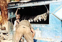 Many small businesses, like this tyre repair shop in Touba, are financed through the Mouride Islamic brotherhood. Senegal Touba Pneu Thies 800x600.jpg