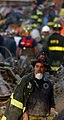 A weary New York City firefighter surveys the destruction as he departs the area. Most of the emergency personnel worked tirelessly for more than 24-hours immediately following the September 11, 2001, terrorist attack that brought down the World Trade Center.