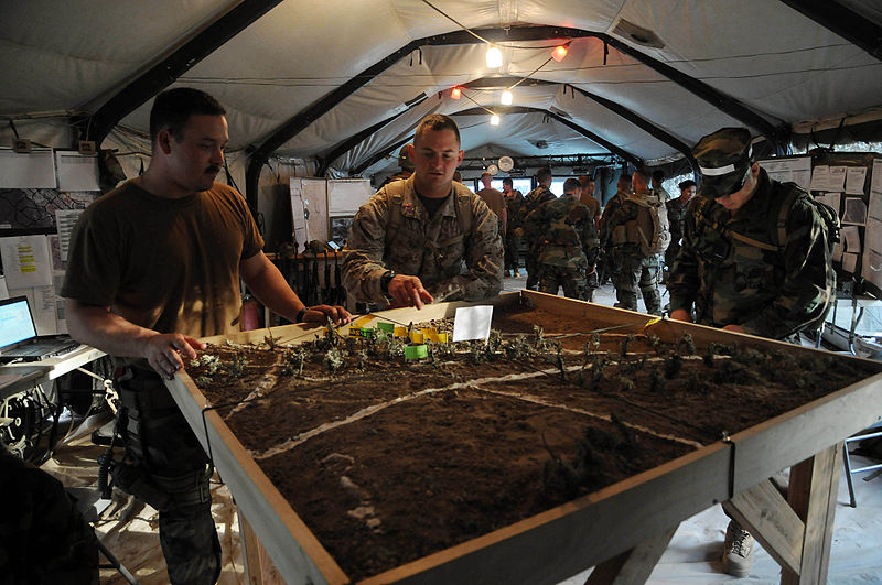 File:US Navy 090421-N-9584H-015 Marine Capt. Tony Friel, center, discusses the use of a terrain model for patrols with Chief Steelworker Robert Taylor, left, during Operation Bearing Duel 2009.jpg