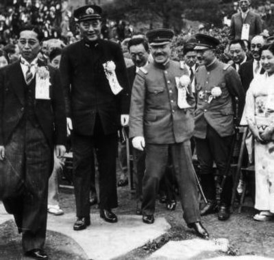 The newly appointed War Minister Itagaki (center, stepping down from the rock) with his vice-minister Hideki Tōjō (right) and Navy minister Mitsumasa 