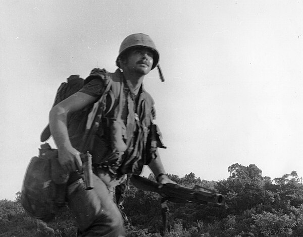 Leader of the 1st squad, 3rd Platoon, Company C, 1/5 Marines, runs under Viet Cong fire during Operation Tippecanoe, 14–16 March 1967