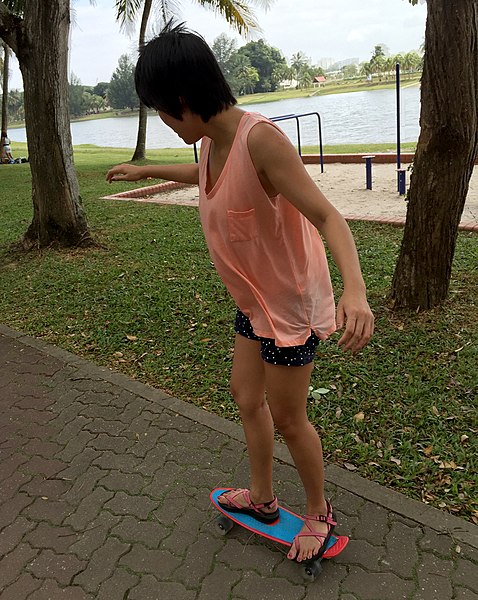 File:A woman riding a penny skateboard.jpg