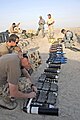 Australian army ammunition technicians and U.S. airmen lay down plastic explosive over munitions during a controlled detonation at a range in Southwest Asia (080620-F-9876D-244).jpg